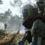 Over-the-shoulder view of a character in a futuristic suit in a wooded environment from Arc Raiders.