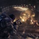 Soldiers in heavy armor fighting monsters in a ruined industrial setting from Gears of War: E-Day.