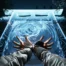 First-person perspective of a character using magical abilities in front of a glowing blue torii gate in Ghostwire: Tokyo.