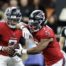 Atlanta Falcons quarterback Michael Penix faking a handoff to running back Bijan Robinson