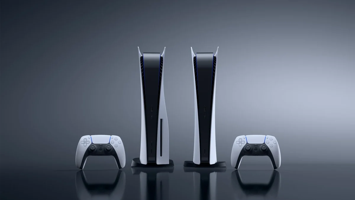 Two PlayStation 5 consoles and two DualSense controllers against a dark grey background.