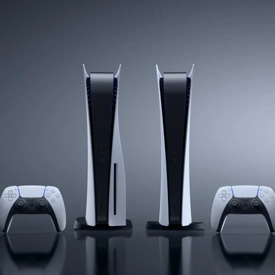Two PlayStation 5 consoles and two DualSense controllers against a dark grey background.