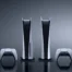 Two PlayStation 5 consoles and two DualSense controllers against a dark grey background.
