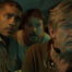 &Quot;Three Men In A Dimly Lit Submarine Interior Look Intently At A Screen, Surrounded By Equipment And Controls, Suggesting A Tense Or Serious Moment In An Underwater Or Scientific Environment.&Quot;
