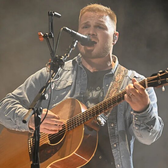 Zach Bryan performing onstage.